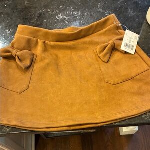 NWT Suede look mini skirt with bows.  Girls sz XS